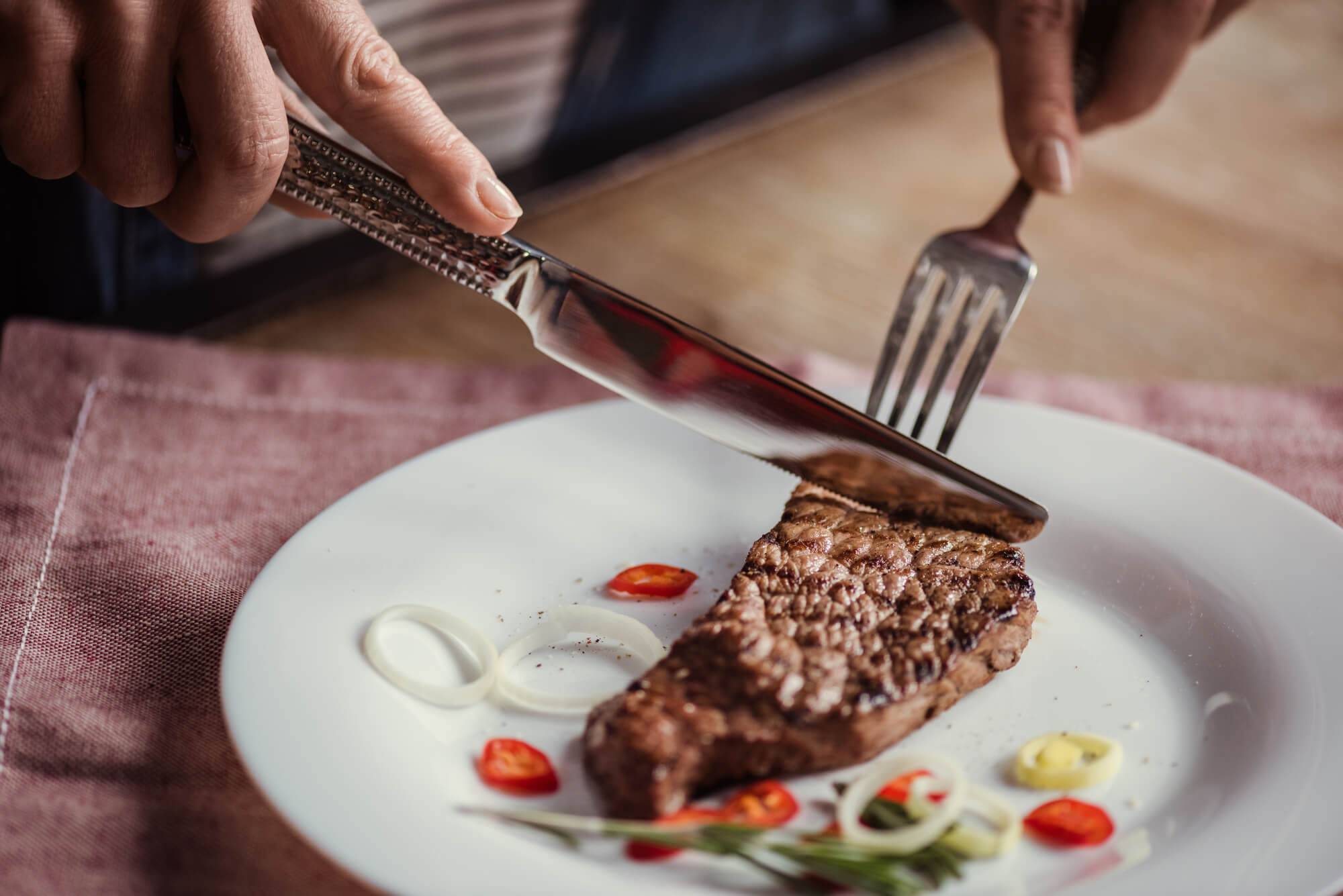 a man eating meat following a weight Loss Program in Palm Beach Gardens